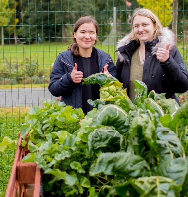 Die Azubis Franziska und Madlin vor dem selbstgebauten Hochbeet